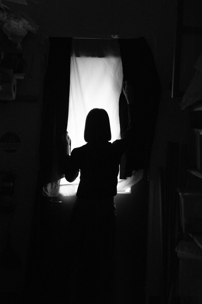 Silhouette of a child standing in the dark, conveying fear, isolation, and the emotional impact of being placed in adult conflicts.