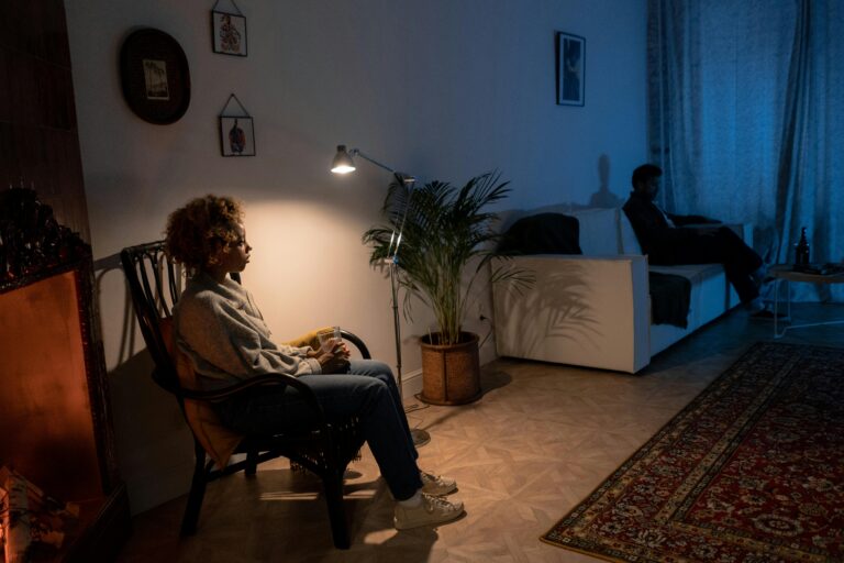 Two people sitting apart, symbolizing emotional distance or relational strain