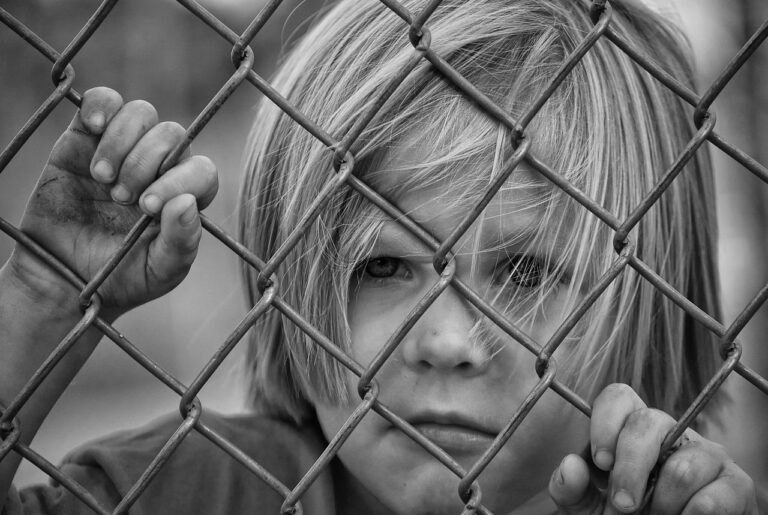 boy, kid, child, fence, sad, unhappy, sad boy, looking, chain link fence, young, caucasian, portrait
